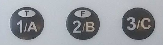 the 1 A, 2 B, and 3 C buttons at the top row of the clicker, with T on 1 A and F on 2 B
